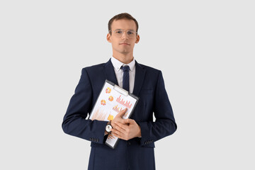 Handsome businessman in eyeglasses with clipboard on white background