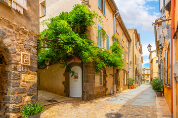 A charming, picturesque street in the medieval village of Grimaud, France, in the hills above Saint-Tropez along the French Riviera.  © Kirk Fisher