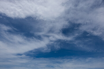 Thin white clouds on blue sky.