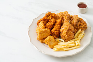 fried chicken with french fries and nuggets on plate