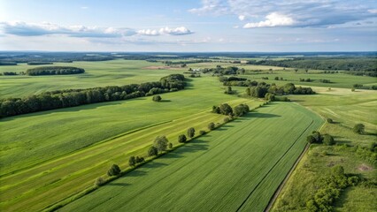Serene Aerial View of Lush Green Farmland and Rolling Hills Under a Partly Cloudy Sky
