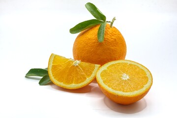 orange with green leaves, sliced ​​navel orange on isolated background