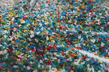 Hands hold clear white plastic pellets, raw materials for various manufacturing processes. These pellets are widely used in industries to produce products like packaging, bottles, and equipment parts.