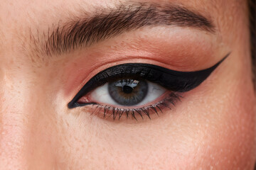 Fototapeta premium A woman with black eyeliner and a pinkish eye shadow