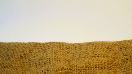 A rustic burlap  isolated white bakground, perfect textured backdrop for showcasing vintage DIY...