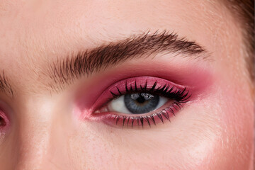 Fototapeta premium A woman with a pink eye shadow and long lashes