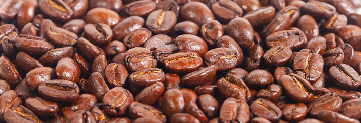 Full screen view, close up of a collection of roasted coffee beans, for background, illustration and pattern design.