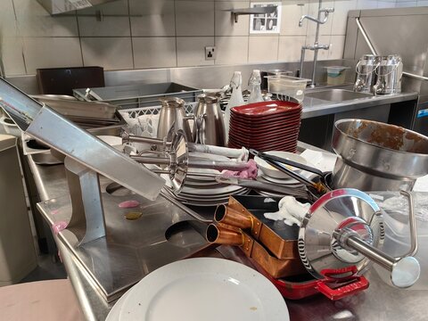 kitchen utensils in a kitchen, messy on steward area.