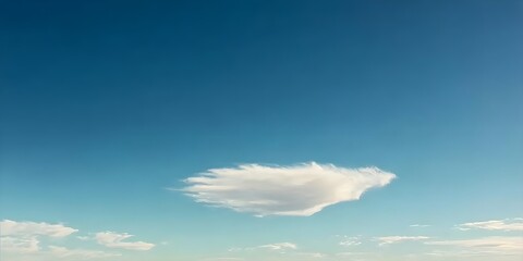 Obraz premium Serene White Cloud Against Blue Sky Background