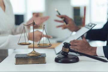 Justice Scales and Gavel:  A close-up shot of a judge's gavel, scales of justice, and legal...