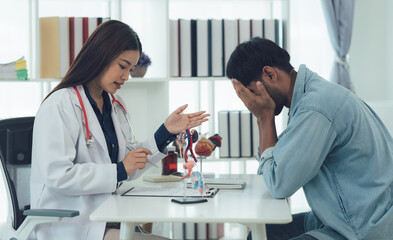 Fototapeta premium Doctor Discussing Diagnosis with Worried Patient: A concerned doctor sits across from a worried patient, offering medical advice and support.