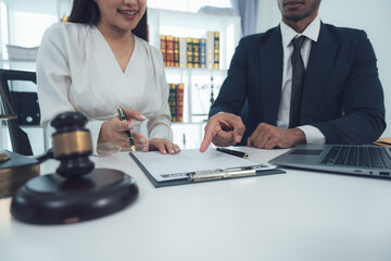 Legal Consultation: A lawyer and client review documents, symbolizing legal advice, expertise, and trust in the pursuit of justice. The image conveys a sense of professionalism and guidance.