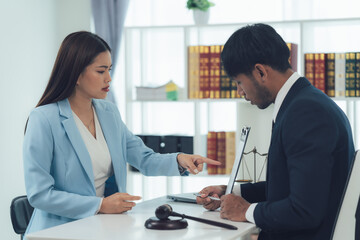 Legal Counsel: Intense Discussion. A serious business meeting between a male and female lawyer unfolds, filled with tension and focus. The scene is set in a professional office setting.