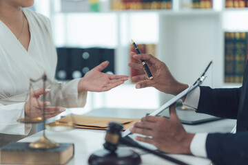 Legal Consultation: A lawyer and client engage in a detailed discussion, their hands gesturing as...