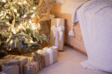 Bright modern bedroom decorated with fir garlands and Christmas trees. Interior in warm minimalism style.