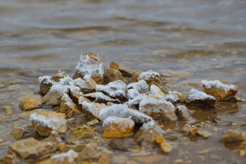 Pile of stones in a salt crust on Lake Baskunchak