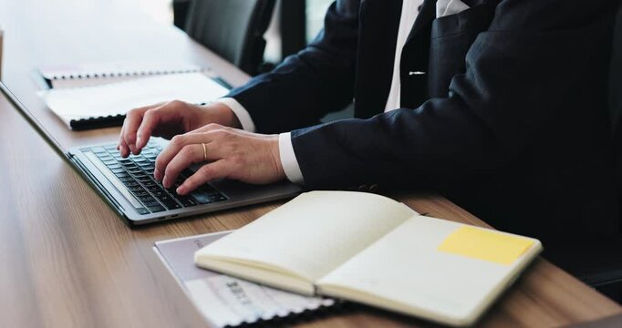Businessman, hands and typing with laptop or book for communication, email or notes at office. Closeup, male person or financial accountant working on computer with diary for business plan in Japan