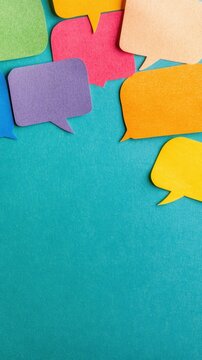 A variety of colorful speech bubbles in different shapes scatter across a bright blue background, inviting conversation and creativity