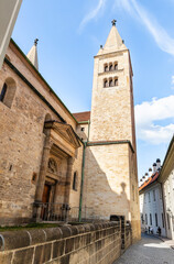 High tower of the St Georges Basilica in Third courtyard of Prague Castle near St Vitus Cathedral in Prague in Czech Republic