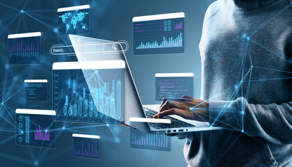 Business person using laptop with floating digital data graphs and charts on futuristic tech background.