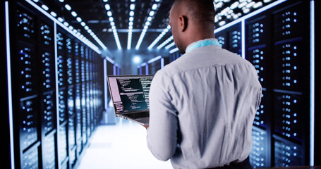 Fototapeta premium Happy Engineer In Data Center Server Room Configuring AI
