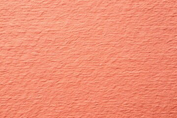 Fototapeta premium Rough grain paper texture with pastel coral background