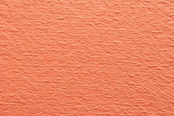 Fototapeta premium Rough grain paper texture with pastel coral background