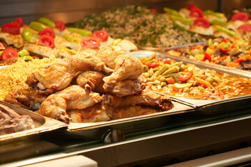 Indulge in Delicious Fried Chicken accompanied by Colorful Sides at a Charming Buffet