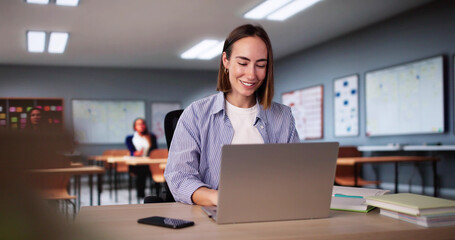 Student Girl In Classroom Using Laptop