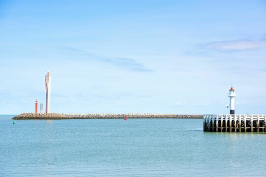 Lighthouse in Oostende, Belgium, standing tall against a blue sky