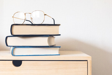 eyeglasses on top of books