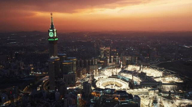 Aerial view of the illuminated Grand Mosque and Abraj Al-Bait Clock Tower in Mecca at dusk, showcasing the holy city&rsquo;s vibrant atmosphere as night falls