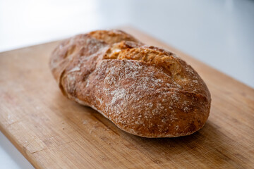 Rustic organic bread on a wooden old board