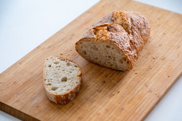 Freshly baked loaf of bread on a wooden cutting board