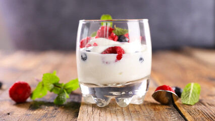 delicious glass of yogurt with berries fruits