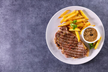 grilled steak, pepper sauce and french fries