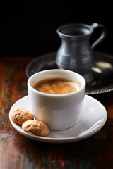 Cup of coffee and Amaretti (Italian biscuits) on rustic wooden background. Rustic wooden background.