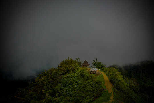 "Mystical Mountain Hut in Orana, Turiscai, Timor-Leste – Foggy Highland Landscape"