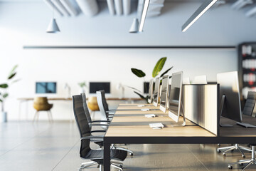 Modern open office layout with wooden desks, ergonomic chairs, computers, and plants in a bright and spacious work environment. 3D Rendering