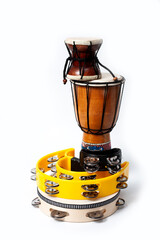 Tambourine and other percussion musical instruments, shot on a white background.