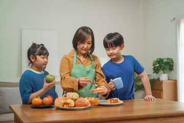 A mother and her children prepare fresh bread, milk, and fruits for breakfast, enjoying a productive and joyful morning together, creating a healthy and nourishing start to their day