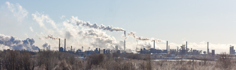 A large industrial city with smoke billowing from the factories