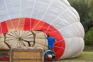 A man is working on a hot air balloon