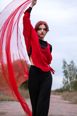 Portrait of a person. Young woman in red. Emotions. Bright image. Fashion