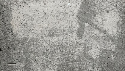 Close-up of a rough, textured concrete wall with a gray tone. The surface shows subtle details, cracks, and imperfections, ideal for backgrounds, industrial themes, or design projects requiring a raw 