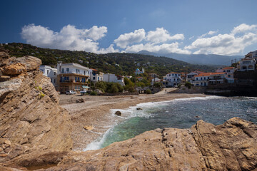 Fototapeta premium Coastal village Karavostamo with beautiful mauntain scenery on the remote Greek Island of Ikaria.