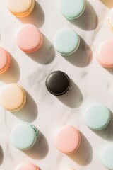 Fototapeta premium Colorful Macarons Display: Vibrant Pastel Treats with One Bold Black Macaron on Marble Surface, Perfect for Dessert Art and Gastronomy Themes.