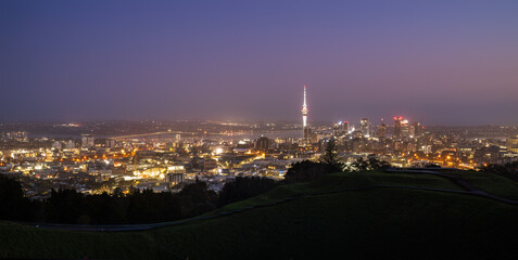Sky Tower and Auckland Harbour Bridge at dawn. Volcanic crater in the foreground. Mt Eden summit. Auckland.