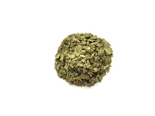 Dried portion of parsley leaves on a white background.