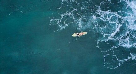 Aerial view of the ocean and surfer girl. Surfing in Midigama. Sri Lanka